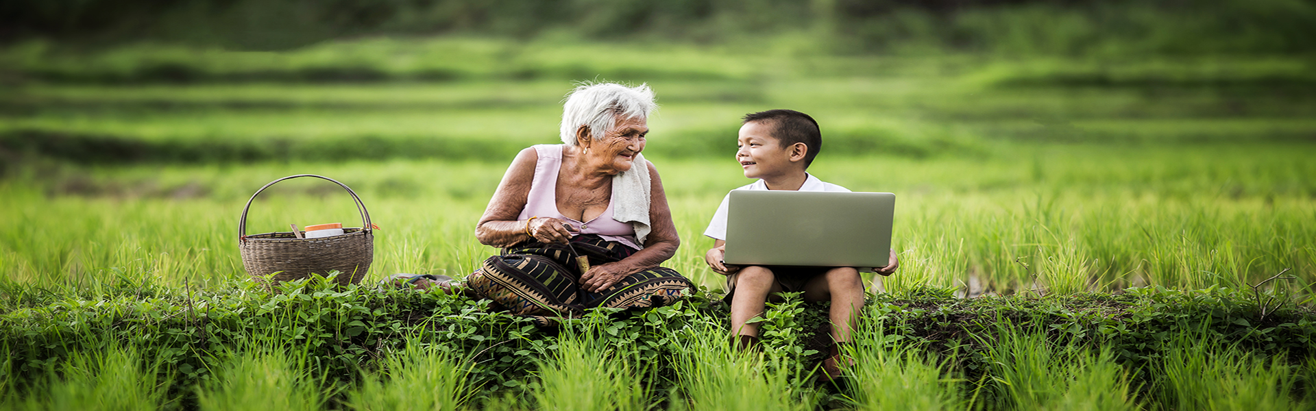 Happy boy and grandmother using laptop, asia thailand.